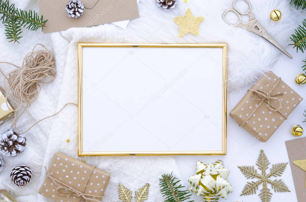 Christmas golden frame mock up made of christmas decoration, balls, cones, golden star, gift box and fir tree. Flat lay, top view. Trendy greeting card, hand craft gifts