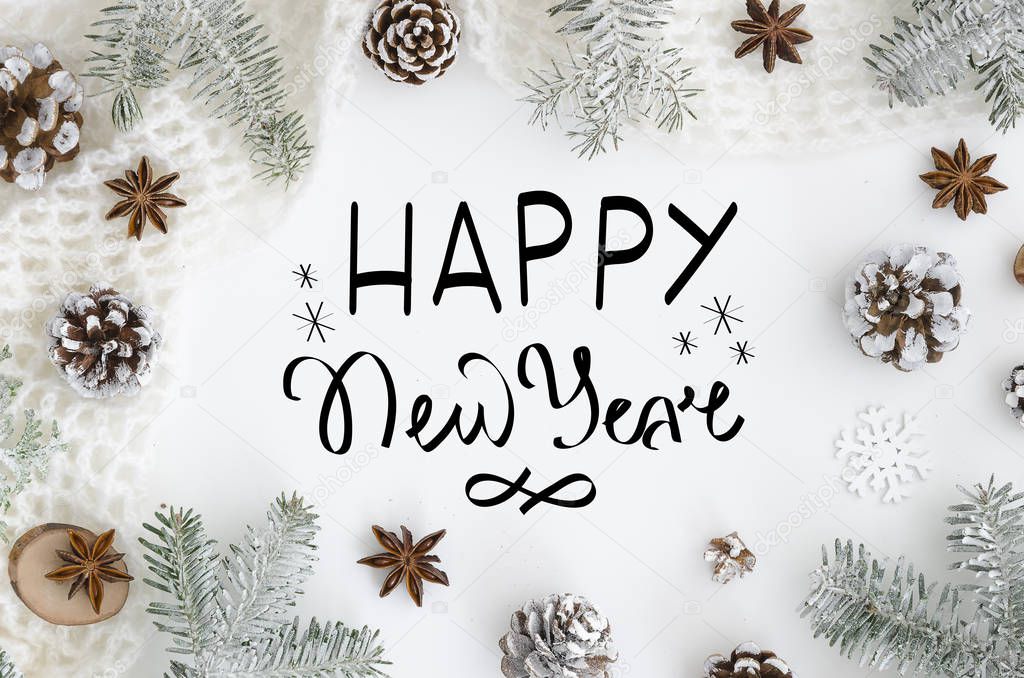 hand lettering greeting card Happy new year on white Background. Christmas Greeting Card. Christmas Decoration Tree, cones, anise, rope, snow. Trendy lettering flatlay