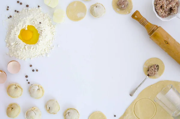 Process som gör ravioli, pelmeni eller dumplings med kött på vitt bord. Platt lekmanna, top view, mockup, kopia utrymme — Stockfoto