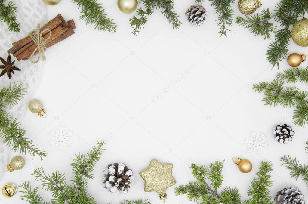 New year frame for hand lettering composition merry christmas isolated on white ackground.Christmas decorations, fir cones and branch,cinnamon sticks, gold balls Top view. Trendy design xmas