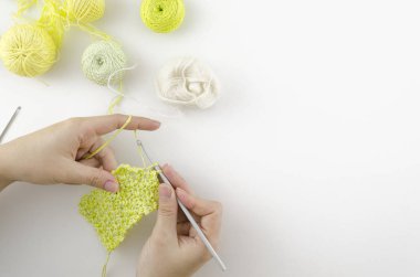 Ev örgü masa çalışma alanı üst görünümü. Needlework kadın elleri köşe çerçeveli. Beyaz arka planda alan kopyalama