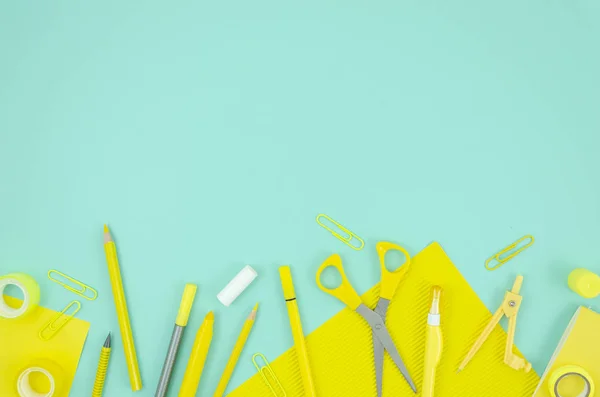 stock image Top view mockup yellow stationary school supplies on blue background. Copy space for text. Back to school concept frame