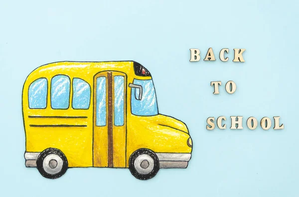 Flat lay drawing school bus with Back to school text on blue background — Stock Photo, Image