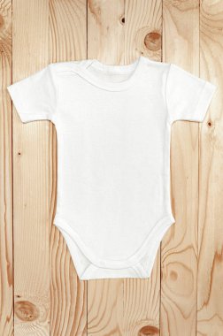 Top view white baby romper bodysuit on wood. Copy space for lettering or your text. Flat lay mockup clipart