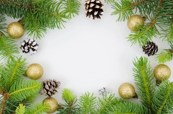 New year frame mockup. Pine cones, fir branches and Christmas balls on white background. Flat lay, top view with copy space