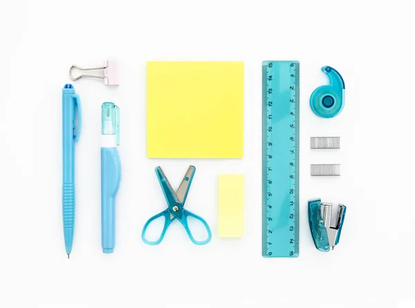 Stationary and school supplies on a white background. Flat lay, top view. Blue and yellow colors — Stock Photo, Image