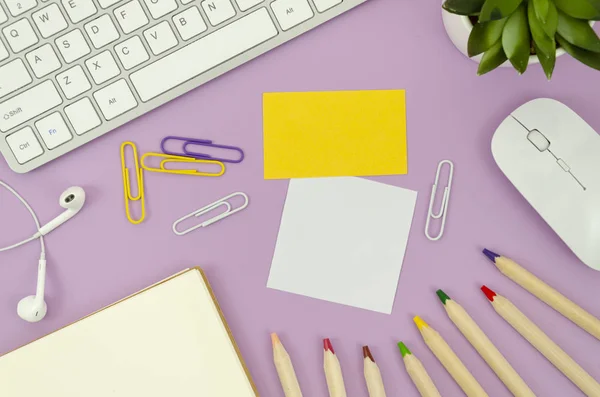 Flat lay mockup student desktop with blank notepad, decorative plant, sticky notes with copy sapce, big pencils and keyboard