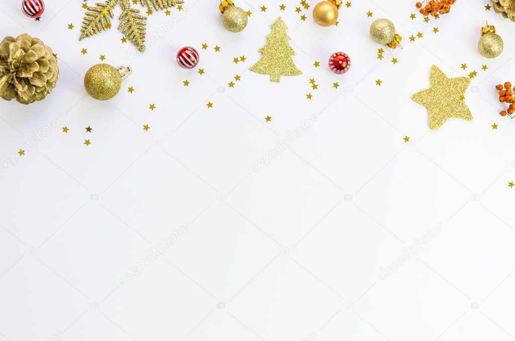 Christmas decoration texture background with pine cones, gold balls and xmas tree toys isolated on white, top view. Copy space