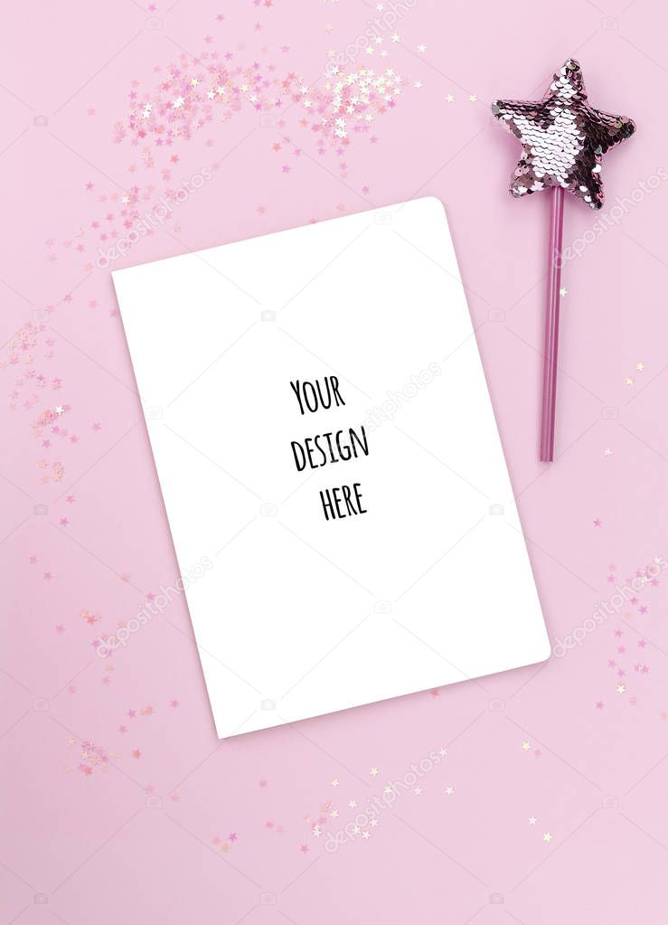 Flat lay mockup blank paper list notepad cover with copy space and Star-shaped magic wand with sequins on a pink background. Female and girls wish list concept