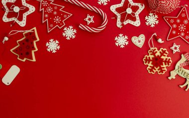 Noel süsleri, Noel süslemeleri ve şeker kamışlarıyla süslenmiş. Kırmızı arkaplanda boşluk kopyala