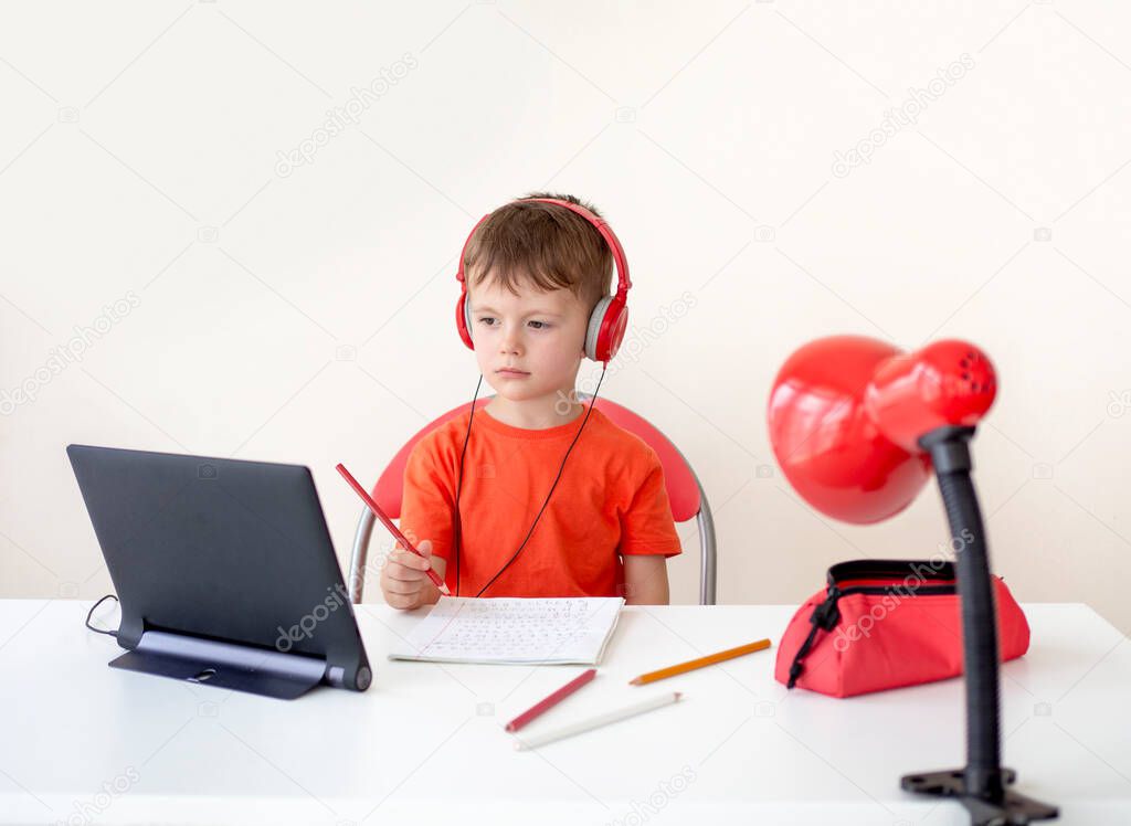 5 years boy video conferencing with tutor on tablet at home. Distance education concept. Kid self isolation using tablet for his homework. Homeschooling, Social Distance, E-learning online education