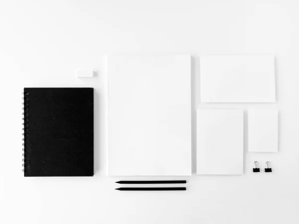 Blank stationery set mockup. Corporate identity template. Copy space for branding identity. Top view, covers, notepads, and business card over white desk