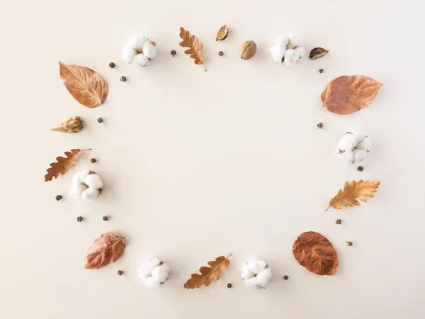 Autumn flat lay frame mockup. Minimal border made of cotton and autumn leaves, cinnamon sticks, anise stars