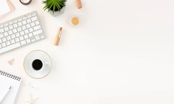 Minimal hiplsters feminine workspace desk with keyboard, notebook, coffee and copy space background. Flat lay