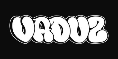 Cesur kelime VADUZ bir grafiti tarzında sunuluyor, beyaz renkle kaplanmış siyah arka plan, kentsel estetiği vurguluyor.