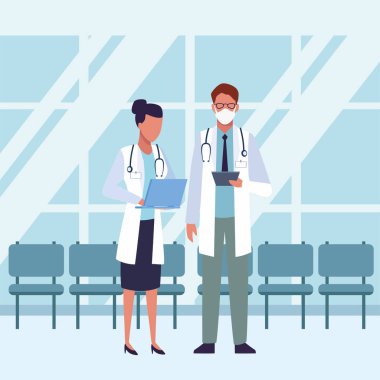 Bir grup doktor bekleme odasının içinde tıbbi maske takıyor.