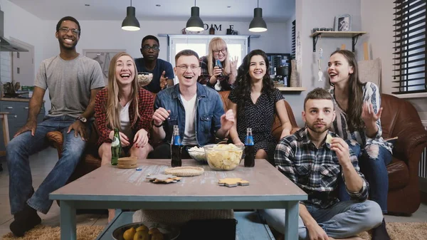 Mixed race friends watch sports on TV. Student football fans supporters get upset. Cheering for favourite sport team. 4K — Stock Photo, Image