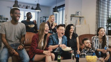 TV programı izlerken çok etnik gruptan oluşan arkadaş. Orta atış. Farklı takım taraftarları tutkulu ve neşeli. 4 k yavaş hareket.