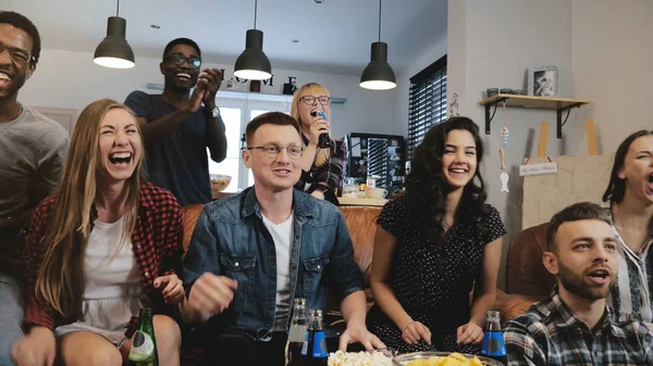 Diverse football fans get wild celebrating win 4K slow motion. Happy multi ethnic friends watching sports on TV. Emotion — Stock Photo, Image