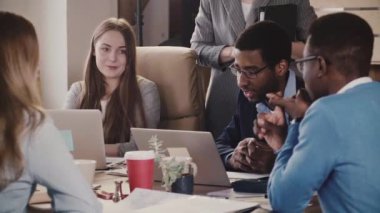 Kendine güvenen genç Avrupa kadın patron çok ırklı çalışanlara konuşuyor. Ofis Toplantı tablo tarafından önde gelen iş kadını.