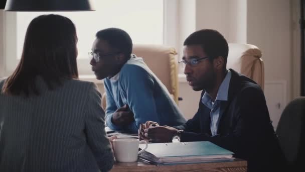 Ung afrikansk amerikansk kontormedarbejder taler med uigenkendelig kvindelig business coach på teammøde slow motion . – Stock-video