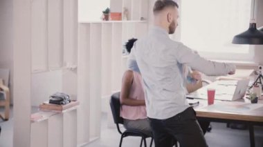 Komik dans eden genç duygusal ofis çalışanı heyecanlı çok ırklı meslektaşları ağır çekim ile birlikte başarı kutluyor.