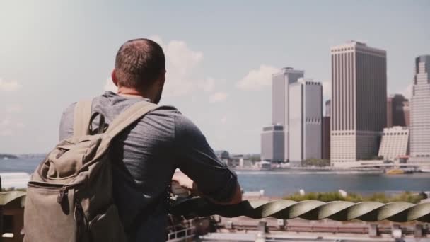 Вид сзади успешного бизнесмена, стоящего и наслаждающегося эпическим небом Манхэттена в солнечном летнем Нью-Йорке, замедленное движение . — стоковое видео