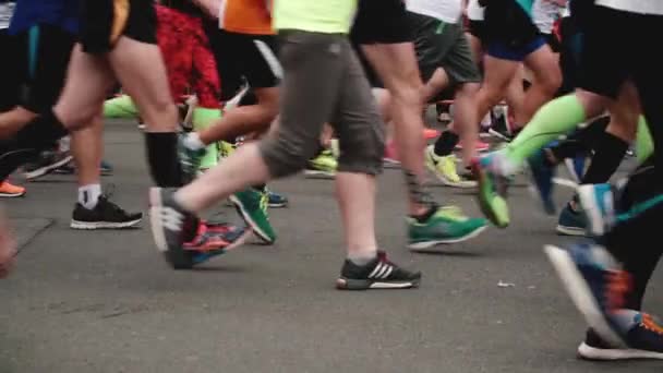 SAINT PETERSBURG RUSSIA, JULY 9 2017 - Side view of legs and feet of running people in different sport shoes slow motion — Stock Video