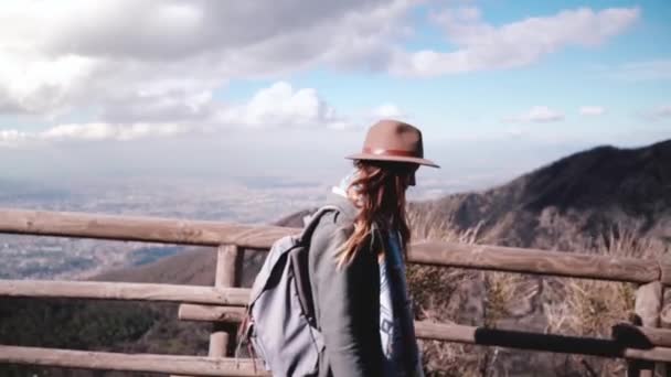 Beautiful slow motion shot of young European female travel blogger walking along Vesuvius volcano pathway slow motion. — Stock Video