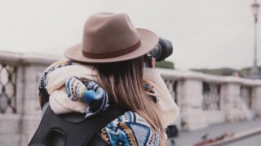 Sırt çantasında şık giysiler almak fotoğraf Roma yavaş hareket ile profesyonel kadın fotoğrafçı close-up arkadan görünüm.
