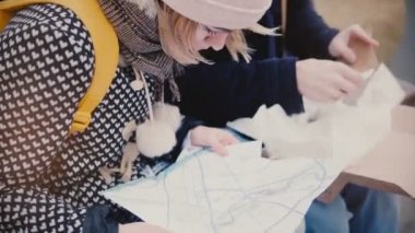 Yakın çekim görünümü turist erkek ve kadın arıyorum kapatmak, bir kış gününde birlikte dışarıda bir şehir harita Seyahat Rehberi