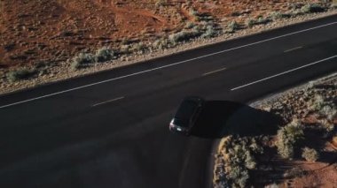 Drone gümüş steyşın araba güzel rocky Dağları ile inanılmaz Amerikan çöl Otoban yol boyunca hareket izler.