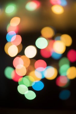 siyah arka plan üzerine parlak renkli bokeh Noel ışıkları