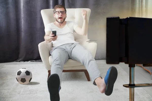 Man Holding Remote Control Watching Football — Stock Photo, Image