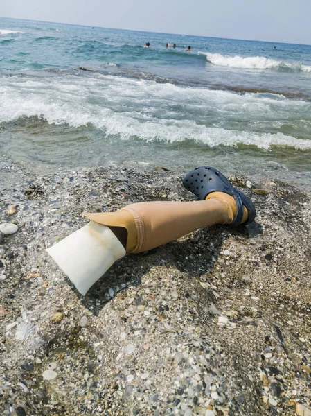 leg prosthesis disabled on the beach as a symbol of recreation for people with disabilities