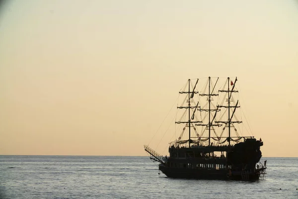 sailing ship at sunset sailing on the sea