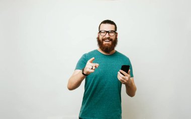 Kameraya dönük ve aralarında en akıllı telefon tutarak mutlu sakallı hippi adam