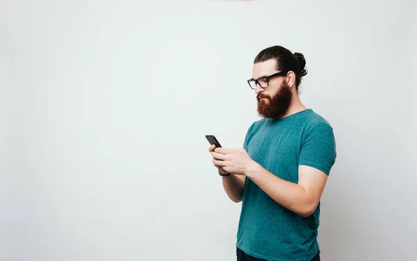 Young Bearded Man Wearing Glasses Looking Serious His Phone — Stock Photo, Image