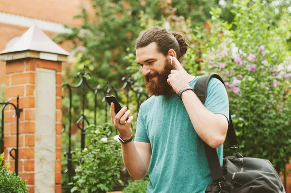 Cheerful Happy Bearded Man Looking His Smartphone Listening Music Earpods — Stock Photo, Image
