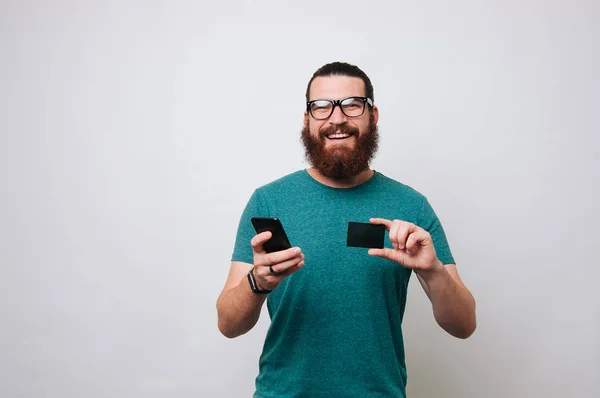 Photo Happy Young Bearded Man Isolated White Wall Background Holding — Stock Photo, Image