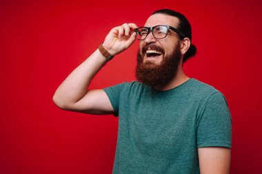 Mutlu genç gülümseyen adam ve gözlük dokunmadan sakallı portait