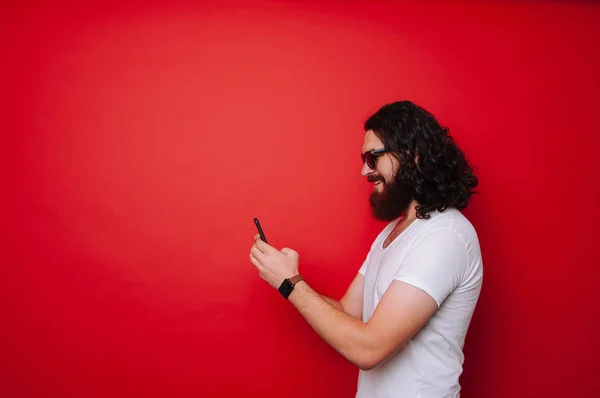 Happy Cheerful Bearded Man Long Curly Hair Using Phone Red — Stock Photo, Image
