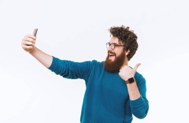 Selfie alma ve başparmak gösterilmesini gülümseyen neşeli sakallı adam