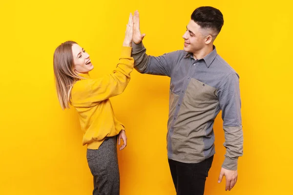 Portrait Happy Smiling Couple Giving High Five Each Yellow Background — Stock Photo, Image