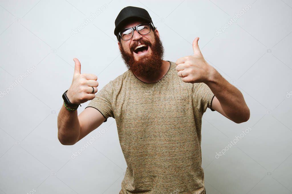 Happy bearded hipster man show his opinion with gesture