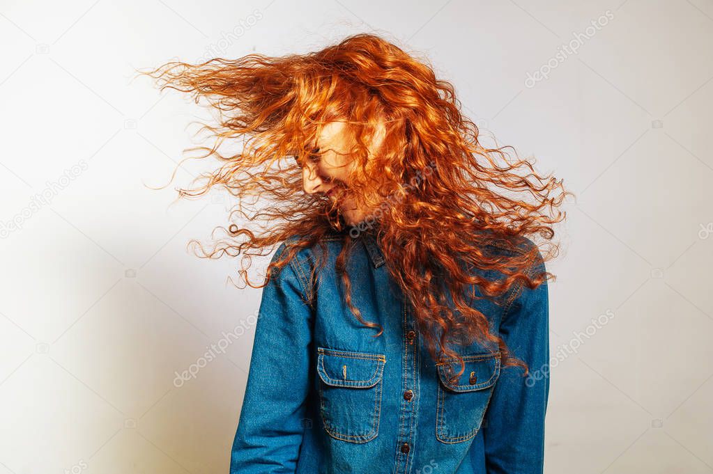 Cheerful curly redhead hipster girl having fun 