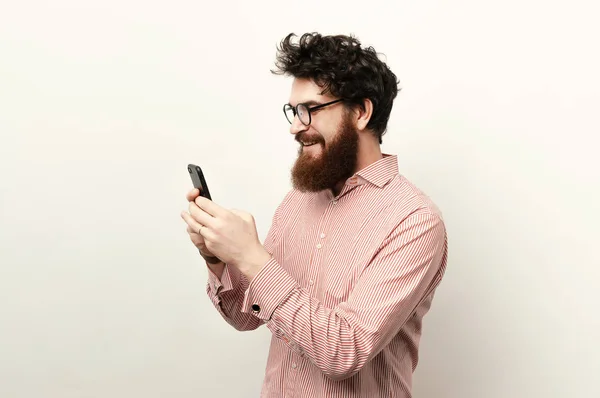 Young Smiling Bearded Man Usig Mobile Phone White Background — Stock Photo, Image