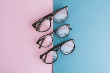 Kadın, erkek gözlük, pembe mavi arka plan ayarlayın. Düz yatıyordu, en iyi görünümü. 