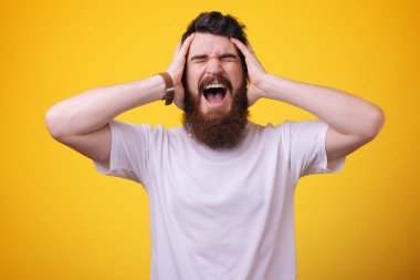 Yine başarısız oldu. Sinirli yakışıklı sakallı adam ellerini kafasına tutun ve gözleri kapalı tutun