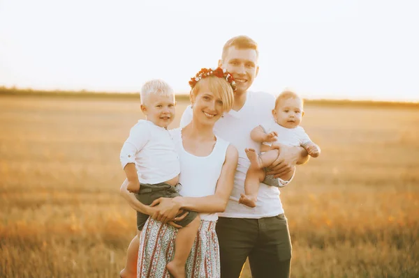 Young Happy Family Walking Outdoor Field Sunset Parents Hold Children — Stock Photo, Image